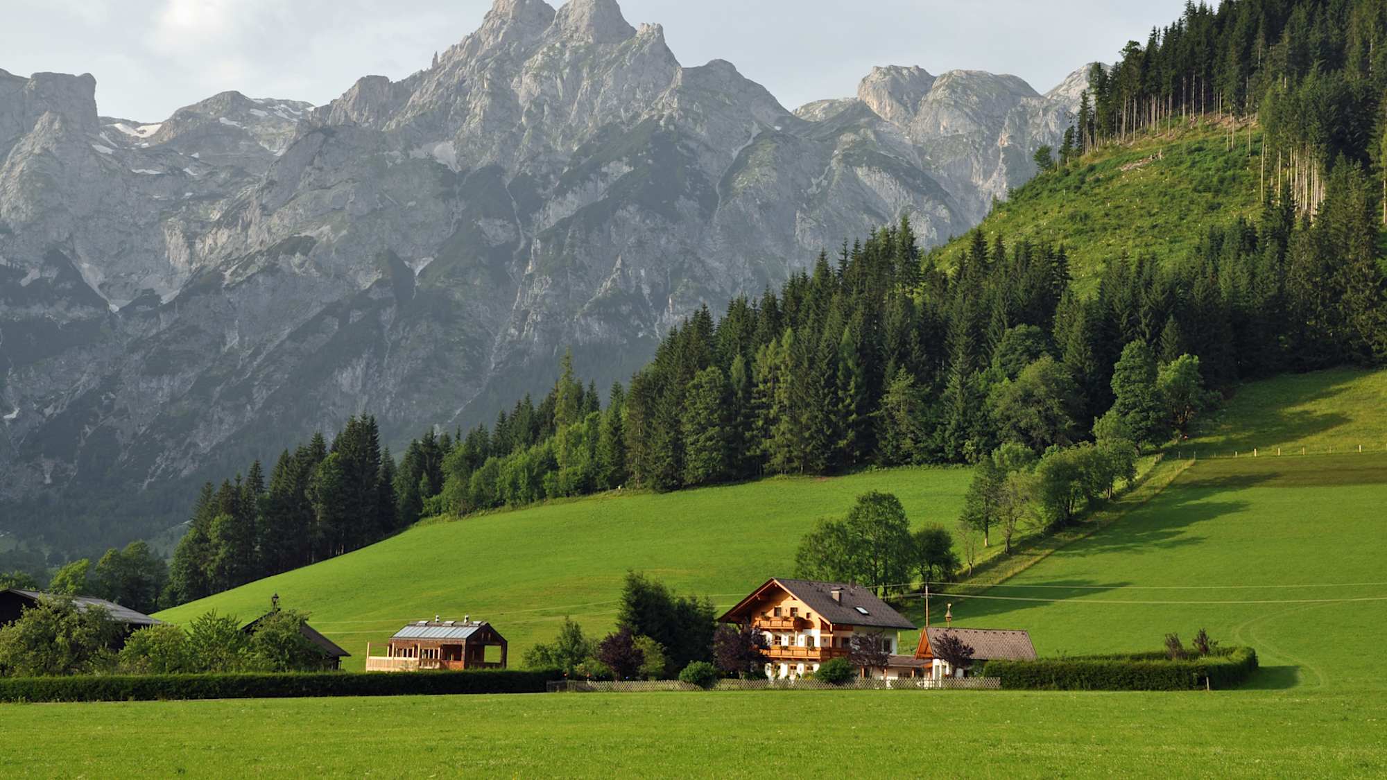 View of Austrian Alps with chalet in the foreground